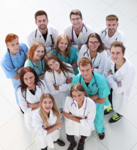 group of diverse medical professionals standing in a circle